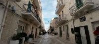 Gasse in Polignano a Mare mit Text VOLARE im Dezember