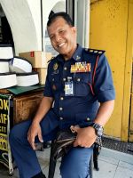 Auch der Polizist holt sich seine handgefertigte Kopfbedeckung ab, Georgetown, Penang