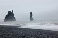 Felsnadeln und schwarzer Sandstrand bei Vik im mystischen Nebel