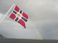 Flagge Hurtigruten und Regenbogen nahe Ålesund