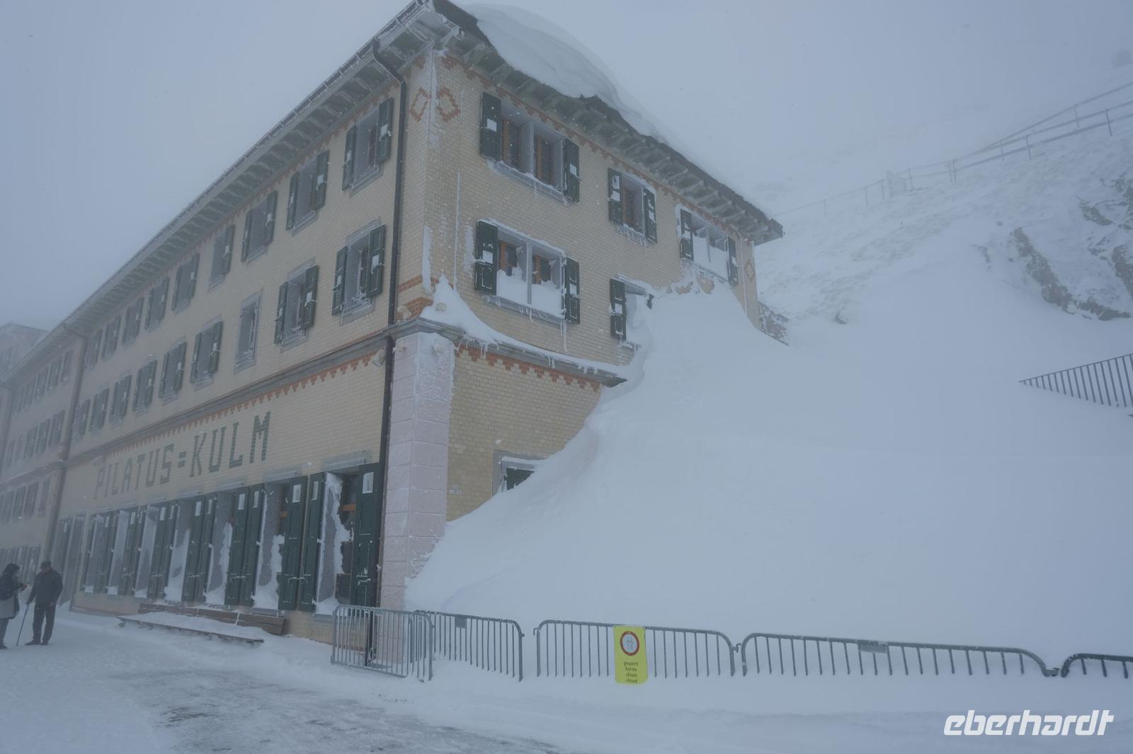 Hinter den Schneemassen verbigt sich eine Eingangstür zum Restaurant