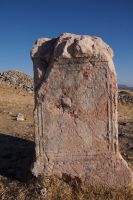Eine kaum noch zu erkennende Inschrift in einem Altar oder Statuenpodest in Acinipo