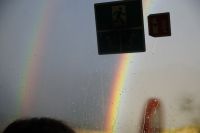 Durch das Busfenster ein doppelter Regenbogen