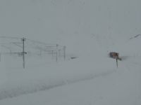 Berninapass, eine Schneewüste. Die Räumfahrzeuge sind auf der Straße und helfen uns, zu passieren.