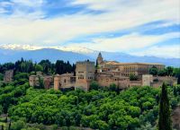Blick über die Alhambra mit schneebedeckten Gipfeln der Sierra Nevada im Hintergrund, Granada, Andalusien, Spanien.