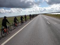 Radreisegäste während der Fahrt auf dem Damm